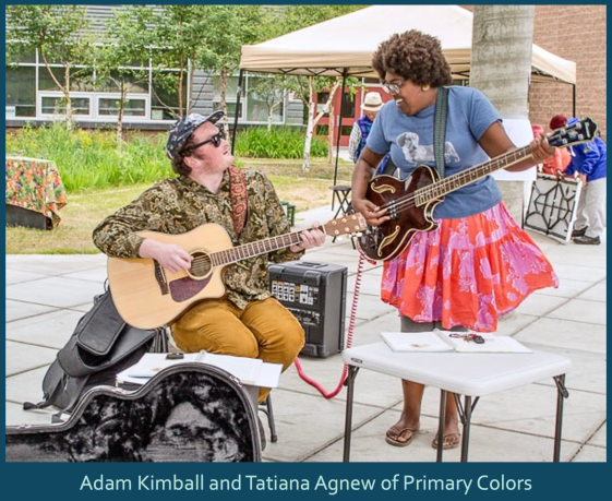 Musicians Amy Joy Luckett and her husband performing live at the farmers market